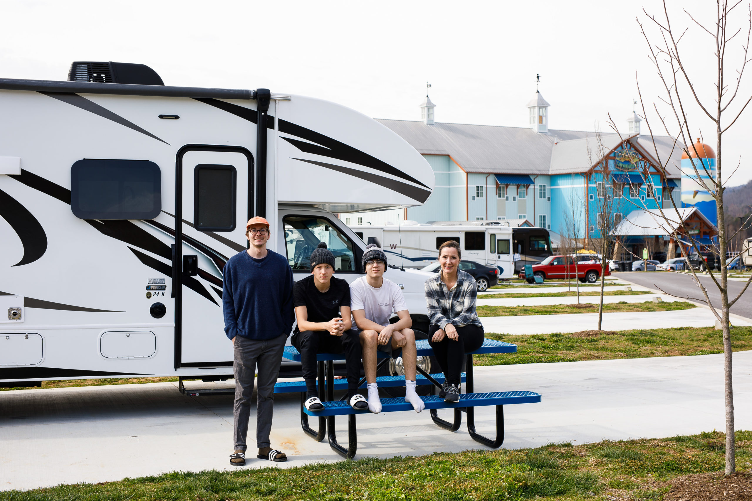 A mom and kids sitting in an RV park
